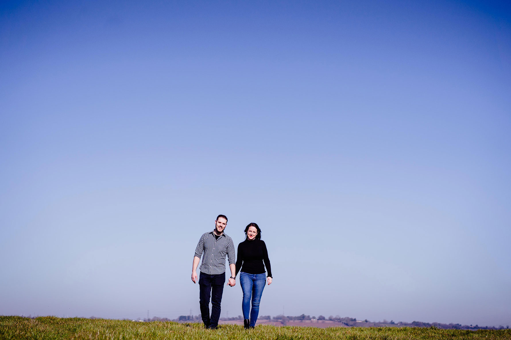 a images from an engagement shoot by Elliot w patching with a happy couple and a beautiful blue sky