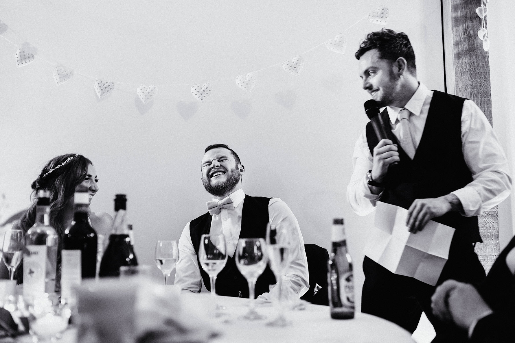 a groom laughs during the bastmans speech