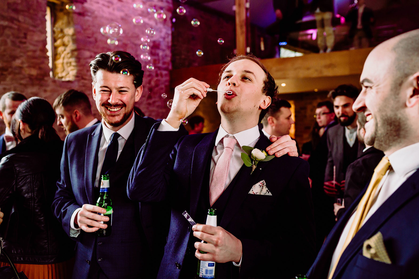 guests blow bubbles at a wedding