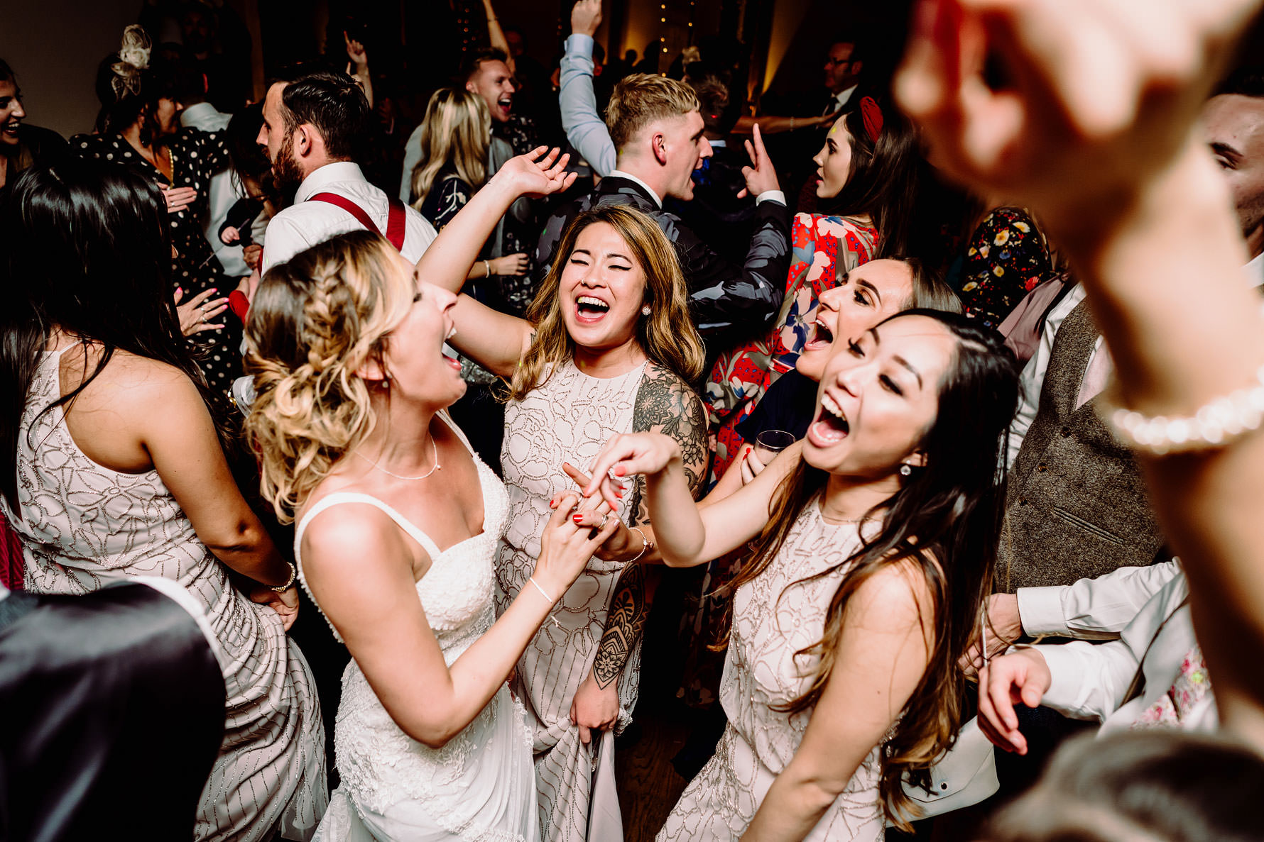 a bride dances with her friends at Dodford manor